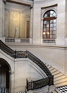 Stairway of Honor of the Conseil d'Etat, with trompe l'oeil painting of an arch and statue on first floor
