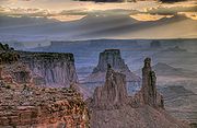 Canyonlands at daybreak. Washer Woman and Monster Tower in foreground, Airport Tower behind. La Sal Mountains in background