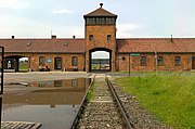 Auschwitz II-Birkenau gatehouse with train tracks