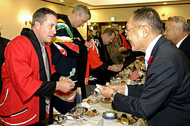 Cmdr. Dan Dusek, commanding officer of USS Fitzgerald (DDG 62), exchanges business cards with Muroran Mayor Masashi Shingu during a reception held in the Japanese Steel Works reception hall.