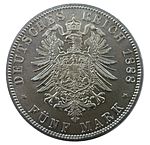 Реверс 5-марочних монет періоду 1871-1888 років. Малий імперський орел з великим Пруським щитом на грудях