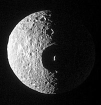 Mimas and the Hershel crater. Note the non-spherical shape of the moon.