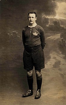 full body shot of Johnnie Wallace wearing his playing strip and boots