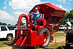 Den första kommersiella bomullsplockningsmaskinen, en International Harvester McCormick Farmall M-12-H från mitten av 1900-talet, är i princip en backande traktor (inledningsvis av typen Farmall H, senare Farmall M) med påbyggnader.[38][39] Till vänster om plockningsenheten skymtar ett plåtskydd som håller undan bomullsplantor från det andra traktorhjulet och mellan föraren och korgen ses tanken för tvättvätska.[26][40]