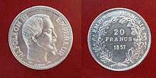 Front and back of a shiny silver coin, front with the picture of a bearded man; back with the value and date surrounded by a wreath of leaves