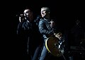 Bono, Adam Clayton, and (barely visible) Larry Mullen Jr. during a concert in Toronto.