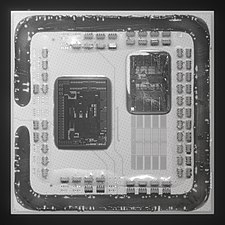 A de-lidded Ryzen 5 5600X. Only one 6-core CCD is present. The contacts for a second CCD are visible.