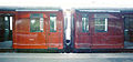 Originally the red coloured CO / CP / COP trains were painted in dark red and featured gilt coloured (with black edging) lettering. In 1973 this was changed to 'bus' red with white lettering. This image shows the two variants side by side.