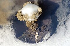 Third place: Sarychev Peak Volcano erupts June 12, 2009, on Matua Island (North Kuril Islands) (POTD) – Credit: Original photo by NASA, uploaded on Flickr by user John, derivative work by The High Fin Sperm Whale. (CC-BY-SA‑2.0)