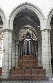 Photographie d'un orgue de chœur, placé dans une arcade.