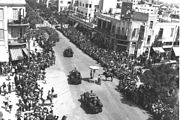 British armoured vehicles parading through Allenby Street in Tel Aviv, in honour of the Silver Jubilee of King George V