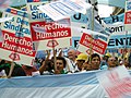 Image 22Union members march in Argentina on Human Rights Day in December 2005. The signs read "Worker rights are human rights..