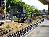 Southern end of the platforms at Putney Bridge station (2007 view), showing the former layout with reversing siding, the World War 2 pillbox defending the bridge, and the northern tip of the bridge