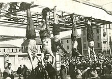 corpses hanging by feet including Mussolini next to Petacci at Piazzale Loreto, Milan, 1945