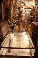 Calvary stone or Rock of Calvary (12th Station of the Cross) and icon on the left side of the Altar of the Crucifixion in Golgotha