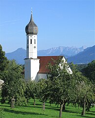 Kirche in Dettendorf im Hintergrund Kranzhorn (links) und Kaisergebirge