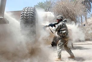 A cloud of smoke and dust envelopes a U.S. soldier seconds after he fired an AT-4 anti-tank weapon at an insurgent position during fighting in Baghdad's Adhamiyah neighborhood.