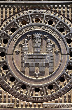 Close-up of a manhole cover with the city seal in Freiburg, Germany