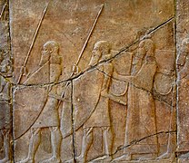 Alabaster bas-relief, procession of Assyrian soldiers and musicians carrying rectangular drums, reign of Sennacherib, from Nineveh, Iraq. 7th century BCE. Pergamon Museum, Berlin.jpg