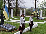 Почесна варта українських пластунів перед могилами повстанців УПА в селі Пикуличі.