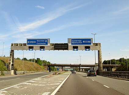 A gantry featuring a large blue sign - A120 (E) Stansted, Colchester