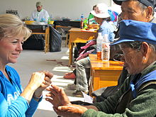 An American Woman Interacting Inter-Culturally in Yunnan Province, China.