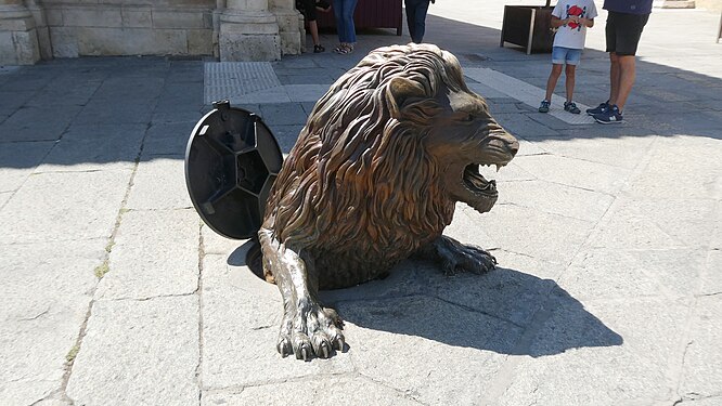 A lion is coming from a manhole, in León, Spain