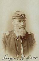 Signed sepia photo shows a bearded man wearing a dark military uniform. He wears a kepi on his head with the number 6.