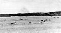 The Invasion of Ie Shima was well prepared but met considerable opposition. Assault boats approach the island as supporting shell fire is lifted from the beaches and moved inland.