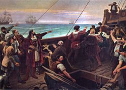 Lukisan yang menggambarkan geladak kapal-layar kayu, yang di atasnya berdiri sekelompok orang menunjuk ke arah cakrawala dan layar-layar sejumlah kapal lainnya terlihat pada latar