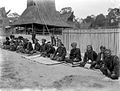 De voornaamste hoofden der Karo-Bataks zitten bij elkaar op de grond in het dorp Kaban Djahé, 1914-1919