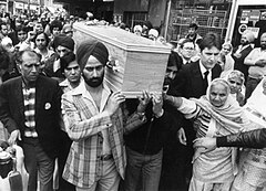 Peach's coffin being carried by Sikhs, as part of a multiracial procession