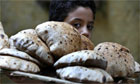 A child carries a plate of bread in Cairo