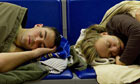 Two people sleep on seats at Gatwick airport