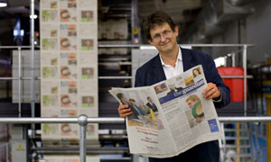 Guardian Editor Alan Rusbridger holds the first copy of the Guardian Berliner newspaper