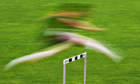 An athlete clears a hurdle during the Swiss Athletics Meeting