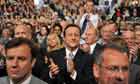 Party leader David Cameron applauds George Osborne's speech