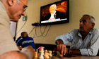 Kosovo Albanians play chess and watch TV in Pristina as judges rule on Kosovo's UDI. 