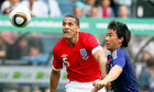 Rio Ferdinand, left, fights for the ball with Shinji Okazaki during England's win over Japan