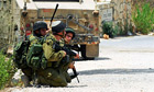 Israeli soldiers take up position near the border with Lebanon after an exhange of fire.