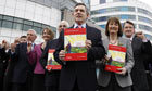 Prime Minister Gordon Brown stands with his cabinet as they hold copies of the Labour manifesto.