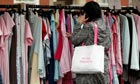 A shopper searches for clothing bargains at Bolton Market.