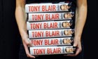 A bookstore employee carries Tony Blair's memoirs, 'A Journey'