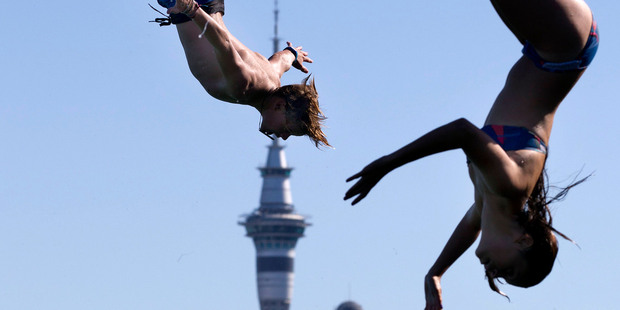 Devonport 15-year-old Hugh Raines (left) synchronises with another jumper 
at Stanley Bay Wharf, across from Auckland's CBD. Photos / Brett Phibbs