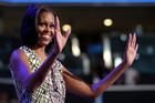 First Lady Michelle Obama waves as she appears at the podium for a camera test ahead of the Democratic National Convention. Photo / AP