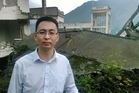 Liu Zhihong, mayor of Yingxiu, stands among the ruins of the Xuankou Middle School.