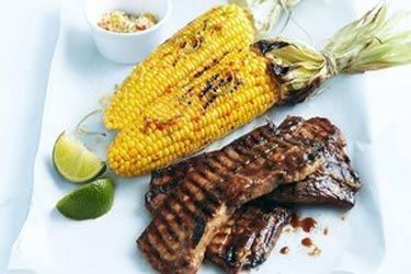 Barbecued ribs with corn and spicy lime butter