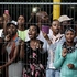 People wait behind a fence to see the casket of Nelson Mandela at its transported back to a hospital from the Union Buildings in Pretoria, South Africa. Photo / AP