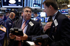 Trader John Bishop, left, and Christopher Forbes work on the floor of the New York Stock. File photo / AP 