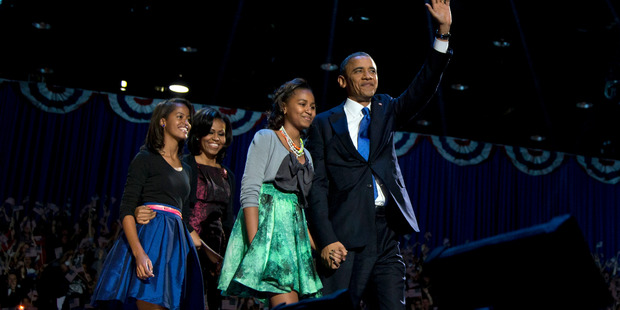 President Barack Obama holds hands with his youngest daughter Sasha, while 14-year-old Malia walks behind with her mum, Michelle.Photo / AP